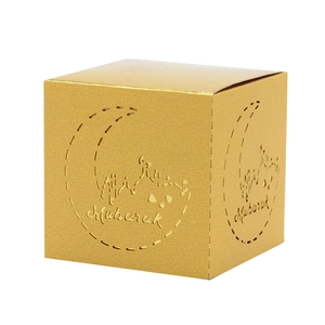 Close-up of golden Mubarak moon gift box with laser-cut mosque design and metallic finish