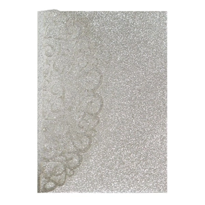 Macro detail of laser-cut silver glitter invitation cover with elegant lace pattern