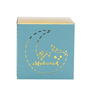 Detail of laser-cut moon and palace pattern on blue Eid Mubarak candy gift box
