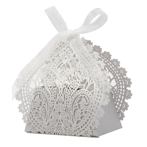 Close-up of laser-cut hollow lace flower pattern on white wedding favor gift box