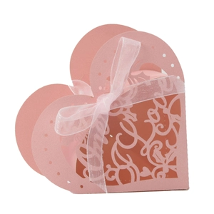 Detail of pink laser-cut hollow heart gift box with intricate floral vine patterns