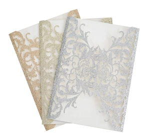 Detailed laser-cut floral wedding invitations in glitter silver, gold, and rose gold finishes