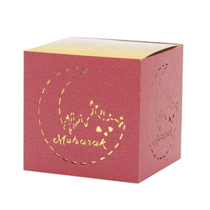 Detail of red square Mubarak gift box featuring golden moon and palace patterns