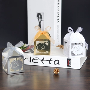 Detailed laser-cut sheep gift boxes in gold, silver and white with ribbon bows
