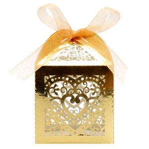 Macro detail of laser-cut heart pattern and organza ribbon on golden gift box