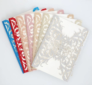 Laser-cut glitter wedding invitations in blue, red, gold, and pink fan-out display