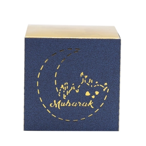 Close-up of deep blue Mubarak candy box with gold foil moon and palace silhouette detail