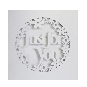Detail of laser-cut 'Just for You' text and floral border on a white square gift card
