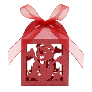Detail of red Christmas snowman gift box featuring laser-cut patterns and a silk ribbon