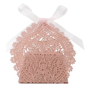 Detailed laser-cut pink lace wedding favor box with a delicate white ribbon bow