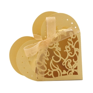 Detailed laser-cut golden heart favor box with Love script and satin ribbon bow