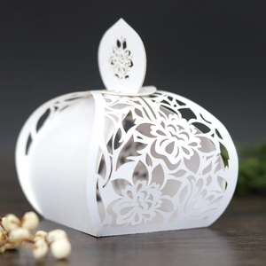 Detailed laser-cut white pumpkin candy box with intricate floral patterns for weddings