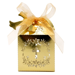 Detailed close-up of golden hollow candy box with cross motif and elegant ribbon bow