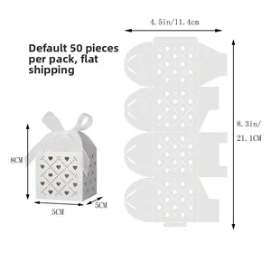 Detailed view of white laser-cut favor box with heart pattern and white ribbon size guide