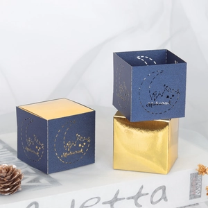 Blue and gold Eid Mubarak gift boxes with laser-cut crescent moon and castle patterns