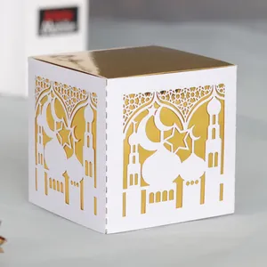 Detail of laser-cut Ramadan gift box featuring mosque and star moon motifs in white and gold