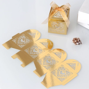 Golden laser-cut heart wedding favor box with ribbon detail and flat template view