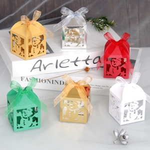 Detail of laser-cut Christmas snowman gift boxes with elegant ribbon bows in various colors