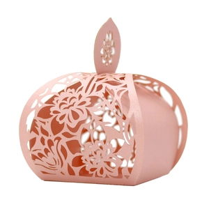 Macro shot of pink laser-cut candy box with elegant floral patterns and pearlescent finish
