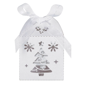 Detail of laser-cut Christmas tree patterns on white gift box with a sheer organza ribbon