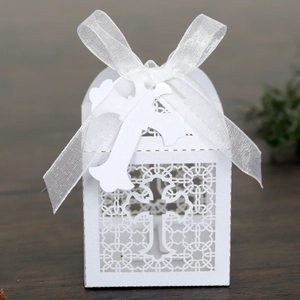 Detailed laser-cut white cross favor box with decorative ribbon for religious events