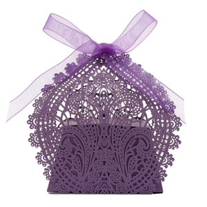 Detailed laser-cut pattern on dark purple hollow wedding favor box with chiffon ribbon