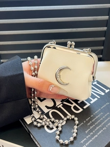 Mini cream leather kiss-lock purse with silver moon logo and elegant chain strap