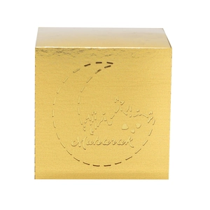 Detail of golden Eid Mubarak gift box with embossed moon pattern and cutout design