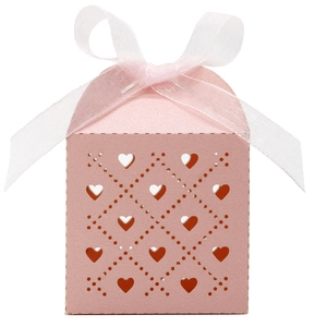 Detailed close-up of pink heart laser cut candy box with white organza ribbon bow