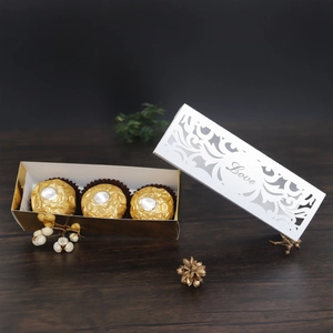 Detail of laser-cut 'Love' gift box with white hollow floral lid and golden base