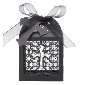 Elegant black laser-cut cross favor box with decorative ribbon for parties and weddings