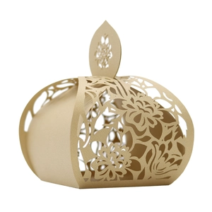 Detailed laser-cut champagne gold favor box featuring intricate floral patterns and handle