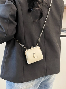 Mini cream leather crossbody bag with silver moon detail and beaded chain strap