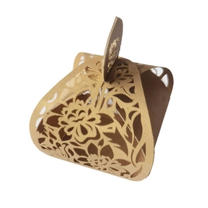 Detailed laser cut floral pattern on gold wedding favor candy box with hollow design
