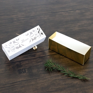 Detail of gold gift box with white laser-cut floral lid and Love镂空 heart design