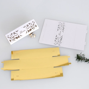 Detail of laser-cut Love heart candy boxes with gold foil interior for wedding decor