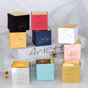 Detail of square Mubarak candy boxes with gold foil moon patterns in multiple colors