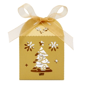 Detail of gold Christmas tree hollow-out candy box with champagne gold ribbon