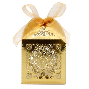 Détail de boîte à bonbons dorée découpée au laser avec motif mandala et ruban