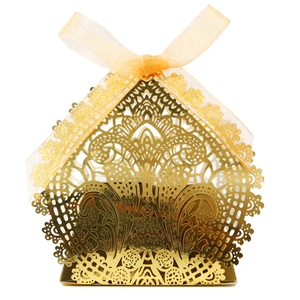 Macro detail of laser-cut lace pattern on gold wedding favor box with ribbon
