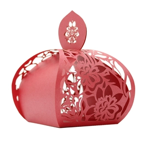 Detailed macro view of laser-cut red rose pattern on the wedding favors candy gift box