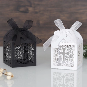 Close-up of laser-cut cross patterns on elegant black and white paper gift boxes