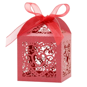 Detail of red laser-cut heart pattern gift box with elegant chiffon ribbon bow