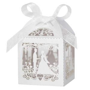 Detail of laser-cut wedding favor box featuring romantic hollow silhouette and ribbon bow