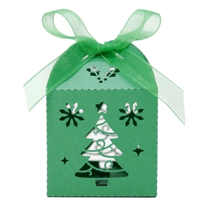 Close-up of green Christmas tree candy box with hollow-out design and silk ribbon bow