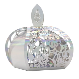 Detail of silver holographic wedding candy box with laser-cut floral patterns and leaf clasp