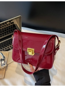 Elegant wine red patent leather crossbody square bag with gold buckle in daily setting
