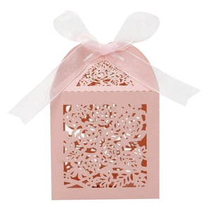 Makroansicht einer rosa lasergeschnittenen Hochzeitsbox mit feinem Rosen-Hohlmuster
