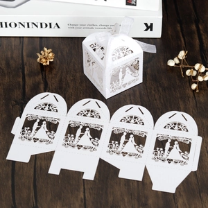 Laser cut white paper wedding favor box with bride and groom silhouette and ribbon
