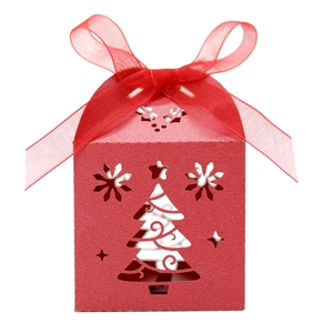Detail of red Christmas hollow gift box with elegant ribbon bow and tree pattern